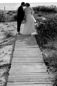 Hochzeitspaar am Strand von Naples mit Holzsteg zum Wasser